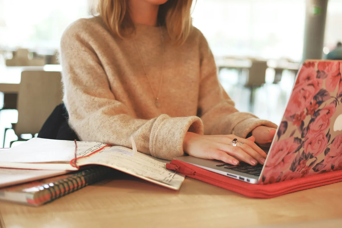 Student using a laptop in a library setting